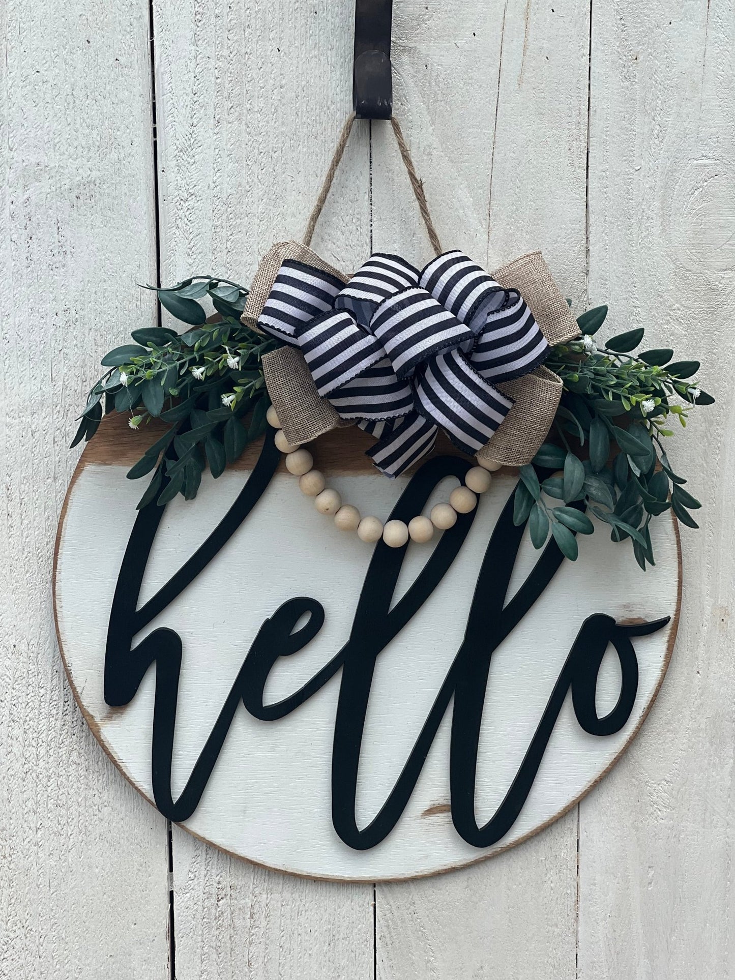 White Hello Door Hanger in rustic wood with black text, 18 inches on white fence.