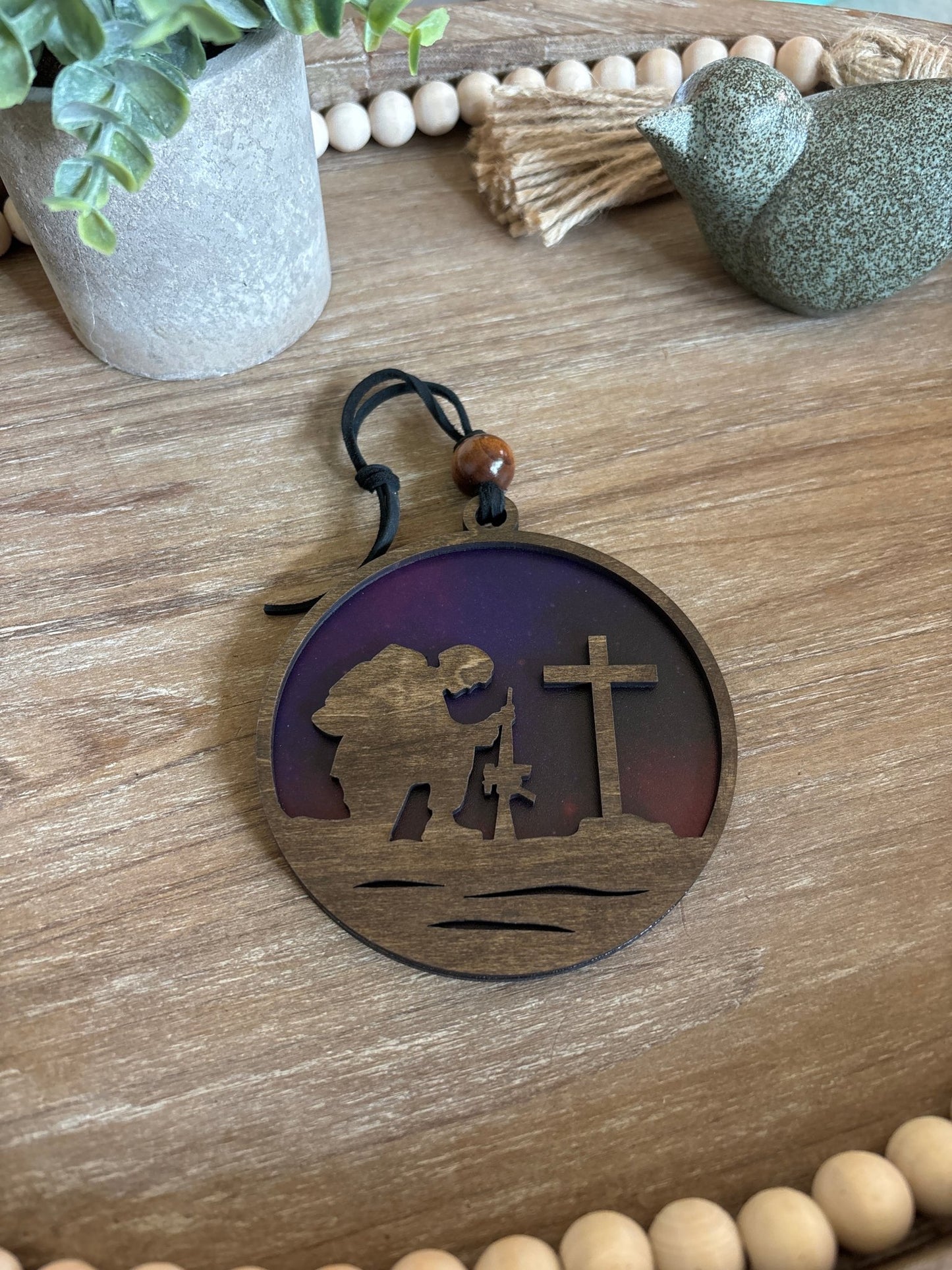 Multicolor suncatcher with walnut-stained wood and acrylic, showcasing a fallen soldier theme.