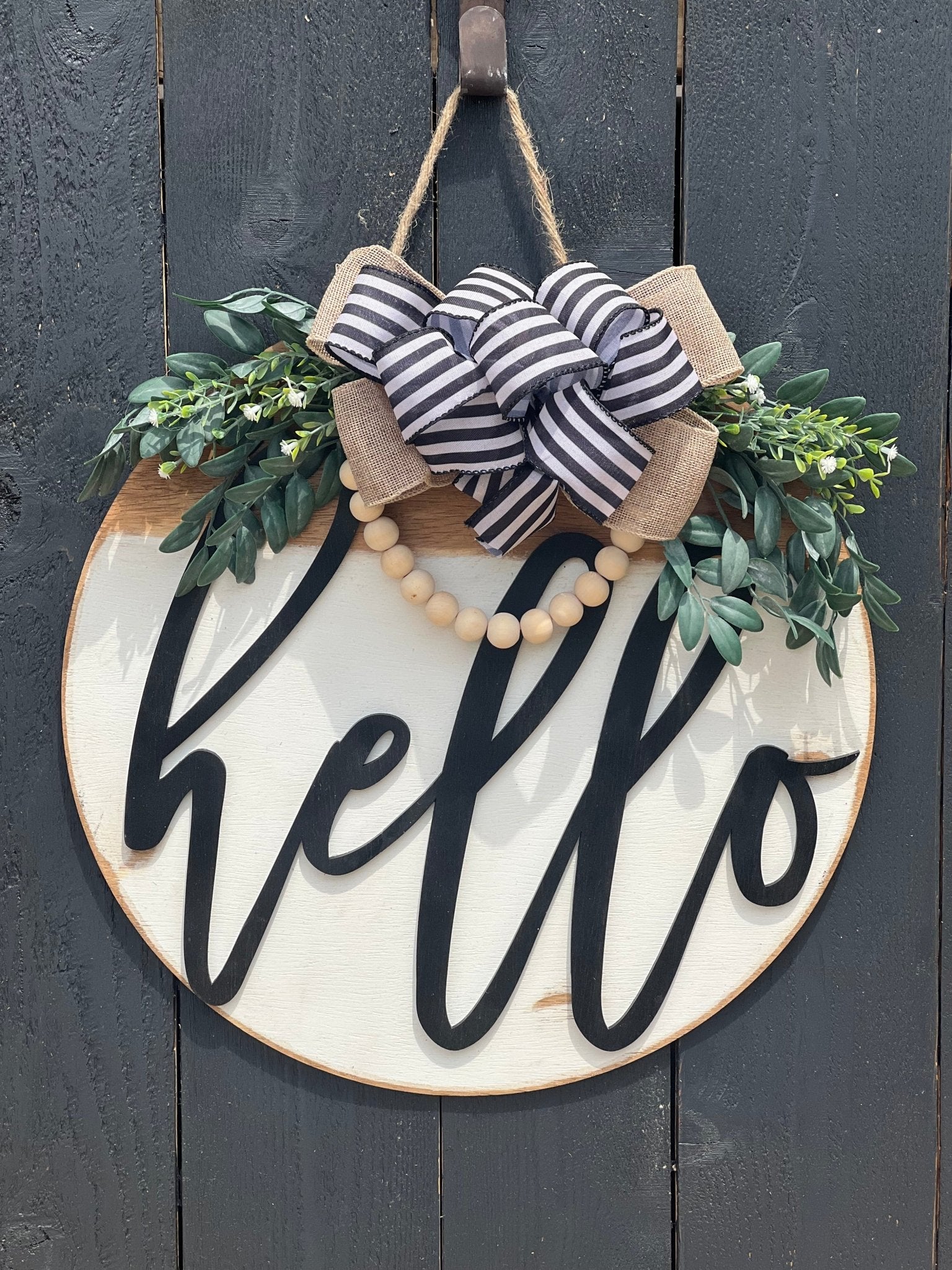 White Hello Door Hanger in rustic wood with black text, 18 inches on black fence.