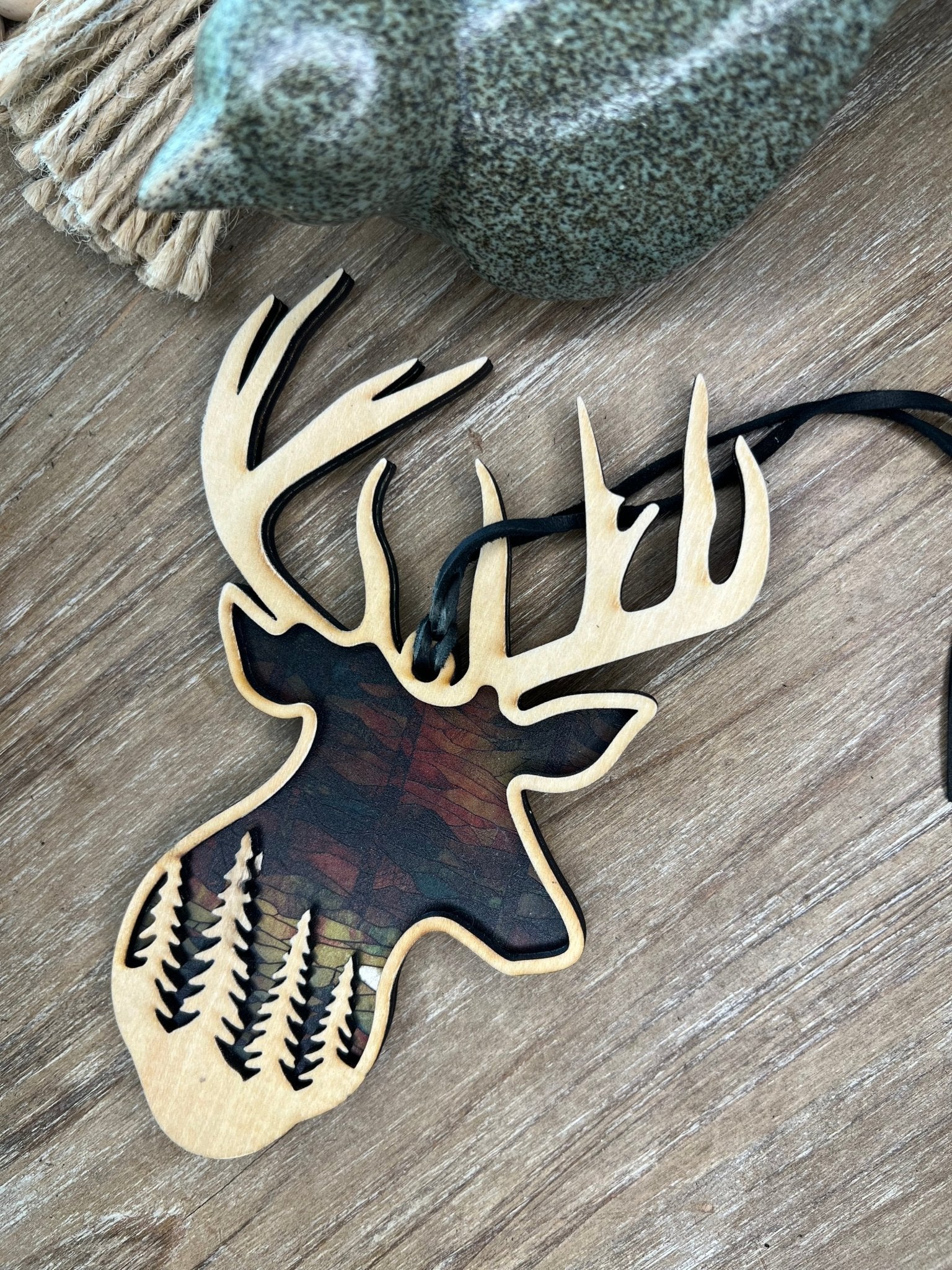 Rustic buck motif suncatcher made of wood and acrylic, multicolor, 6.25x4 inches.