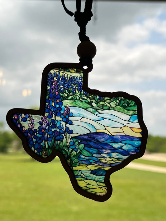 A rustic-modern suncatcher featuring a bluebonnet design with stained glass effect, made of wood and acrylic in sunlight.