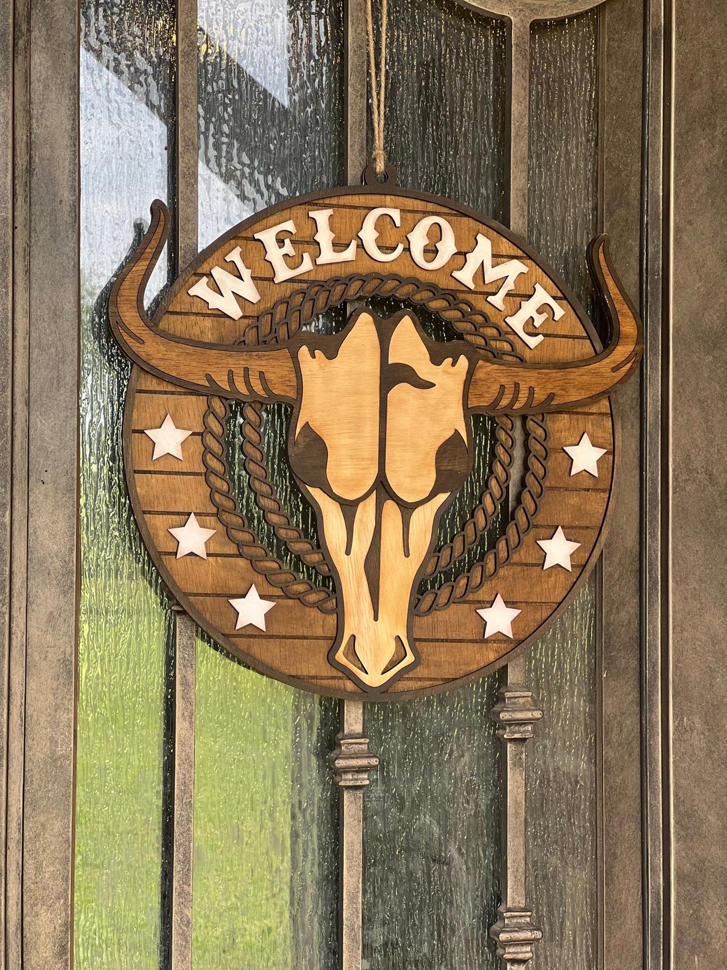 Rustic Longhorn Wood Door Hanger with natural wood texture and warm walnut stain on metal door.