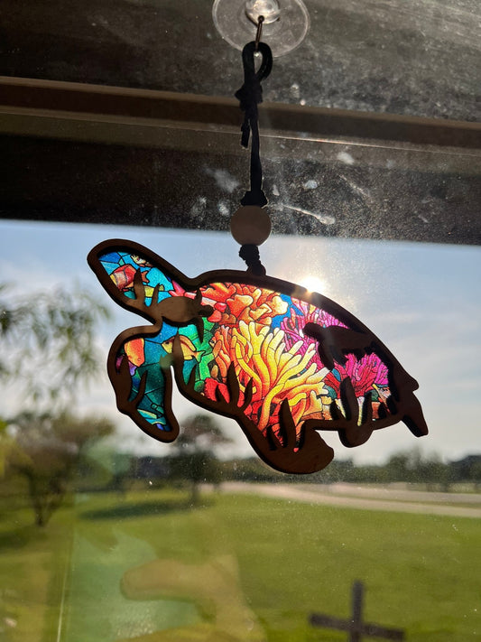 Sea turtle suncatcher with natural wood and multicolor acrylic, perfect for rustic and beach-themed decor in sunlight.