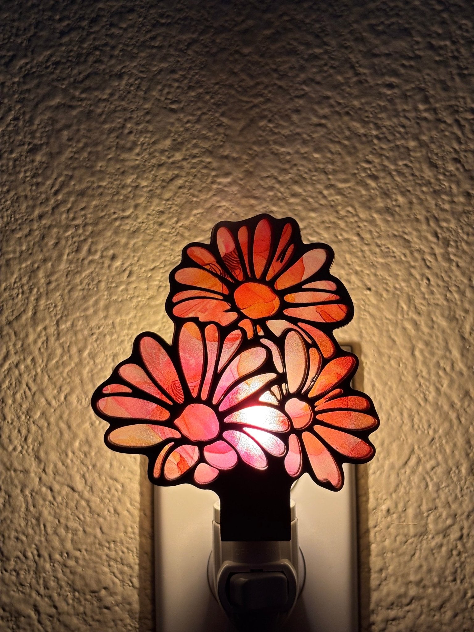 Daisy Flowers Nightlight in rustic wood and multicolor acrylic, 5.5” x 3.5”, glowing warmly lighted.