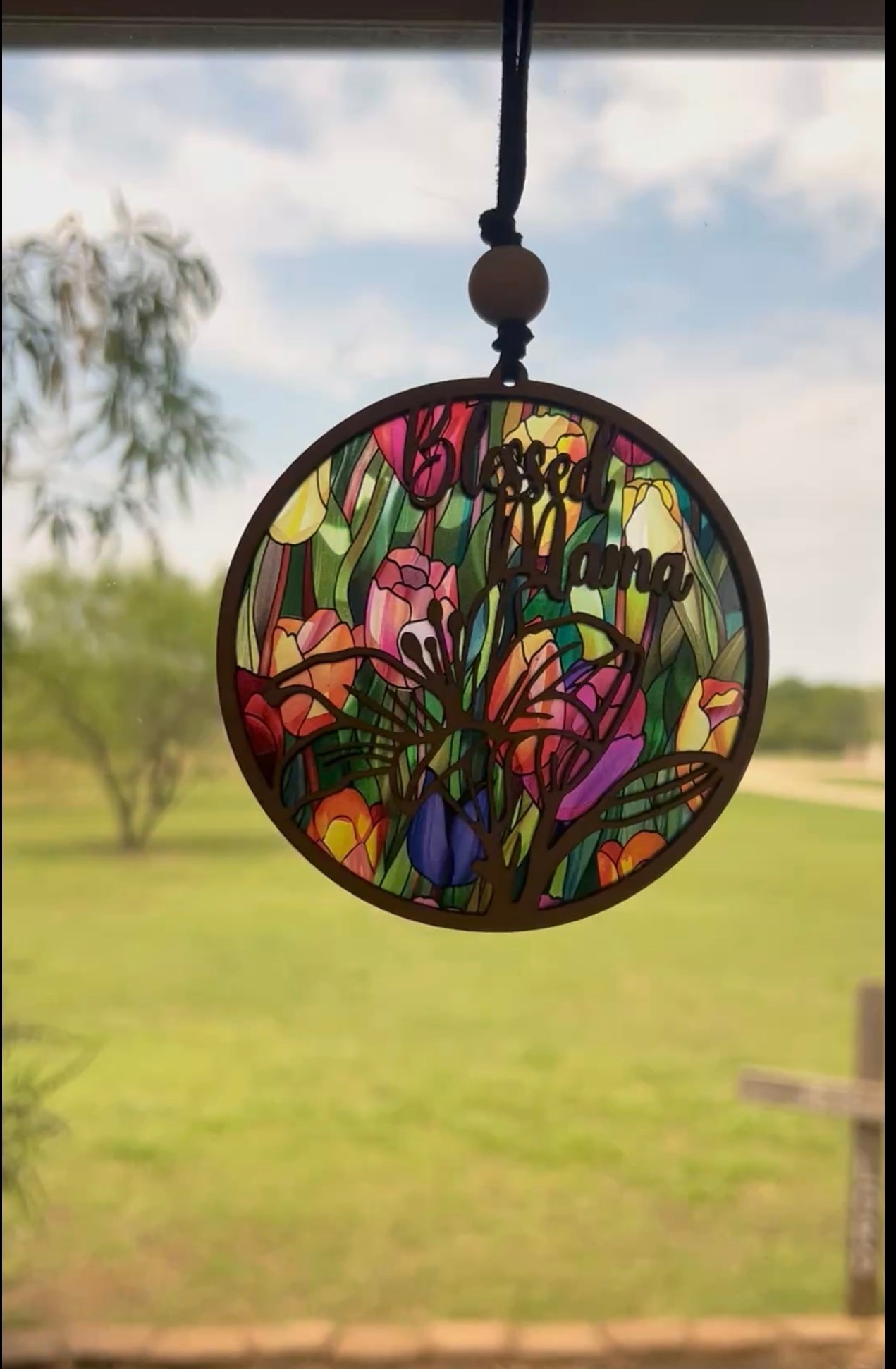 Rustic multicolor Blessed Mama suncatcher made of wood and acrylic, perfect for home decor in sunlight.