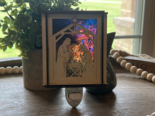 Natural wood Christmas Nativity Lantern Nightlight with multicolor designs in sun.
