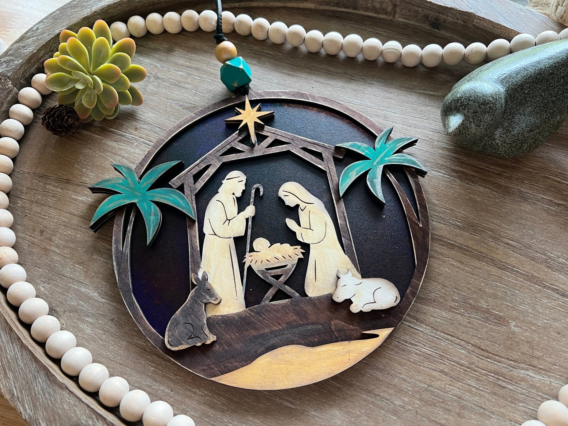 Haunted House Lantern Nightlight with stained glass effect in golden oak wood, perfect for rustic decor- in natural light on a tray.