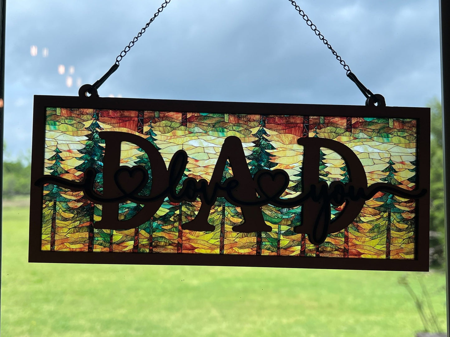 Handmade suncatcher with wood and acrylic in multicolor, perfect for decor in sunlight.