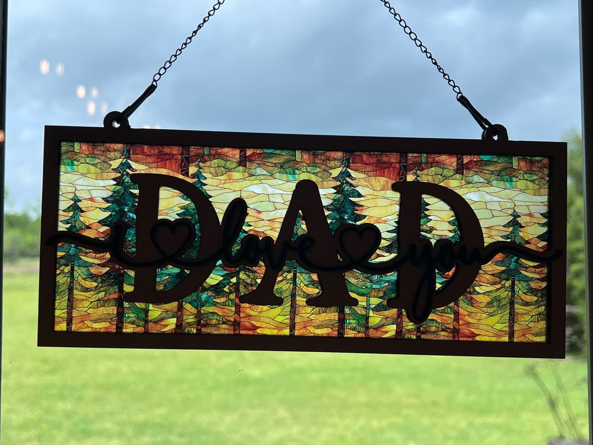 Handmade suncatcher with wood and acrylic in multicolor, perfect for decor in sunlight.