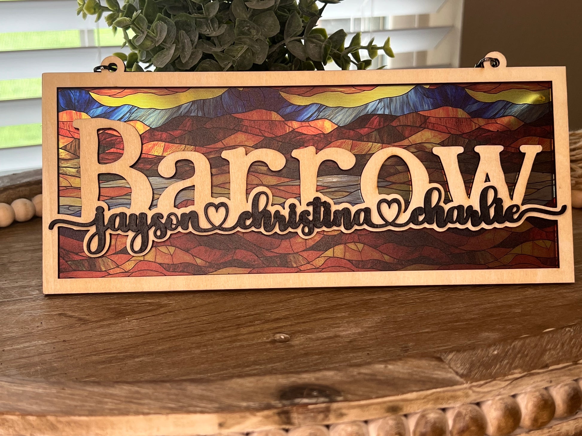 Family Personalized Suncatcher in natural wood and multicolor acrylic, showcasing rustic-modern style. in light