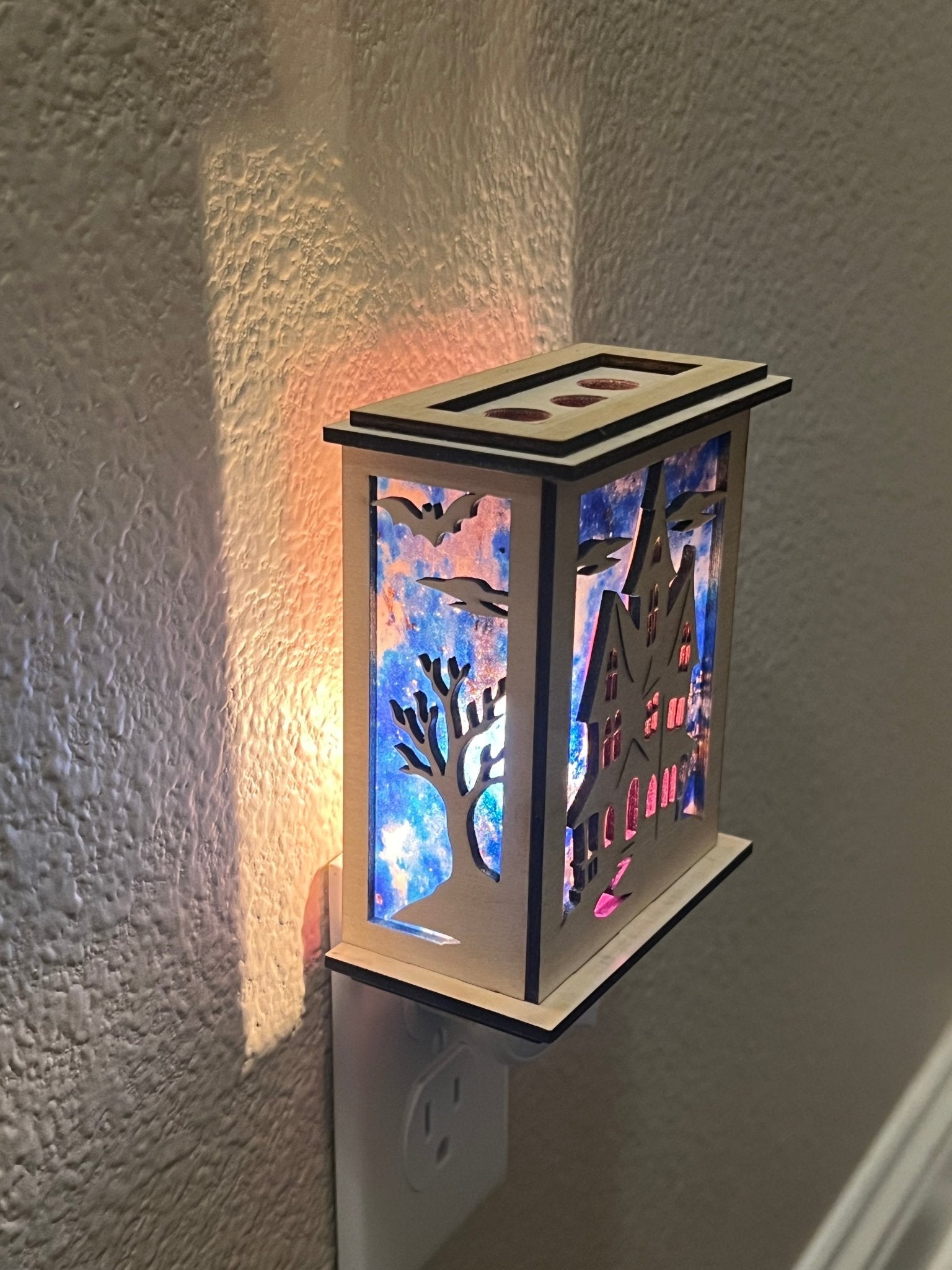 Halloween Haunted House Lantern Nightlight made from wood and acrylic, showcasing rustic charm and multicolor glow  lighted in a lit hallway with right view.