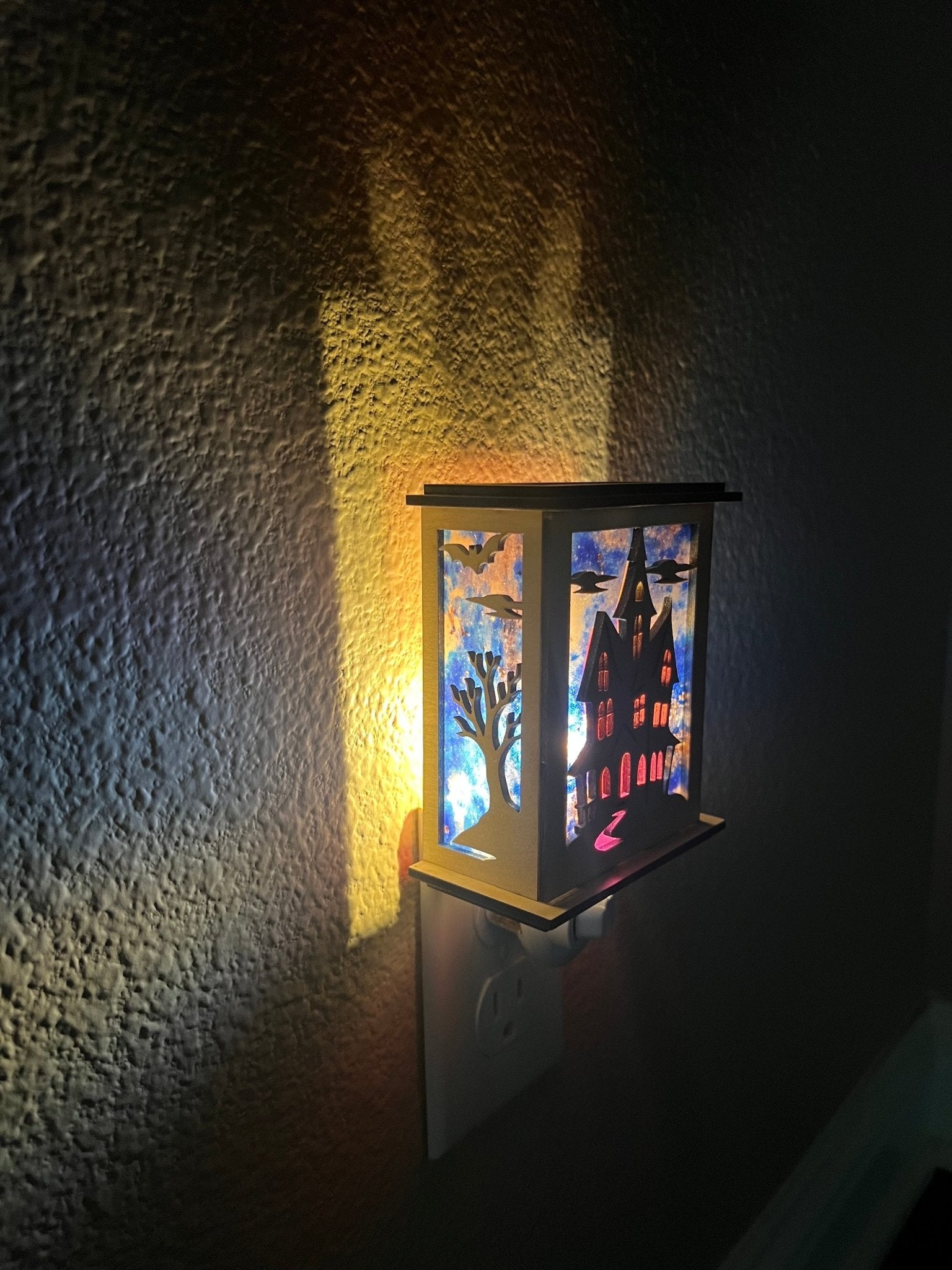 Halloween Haunted House Lantern Nightlight made from wood and acrylic, showcasing rustic charm and multicolor glow lighted in a hall left view.