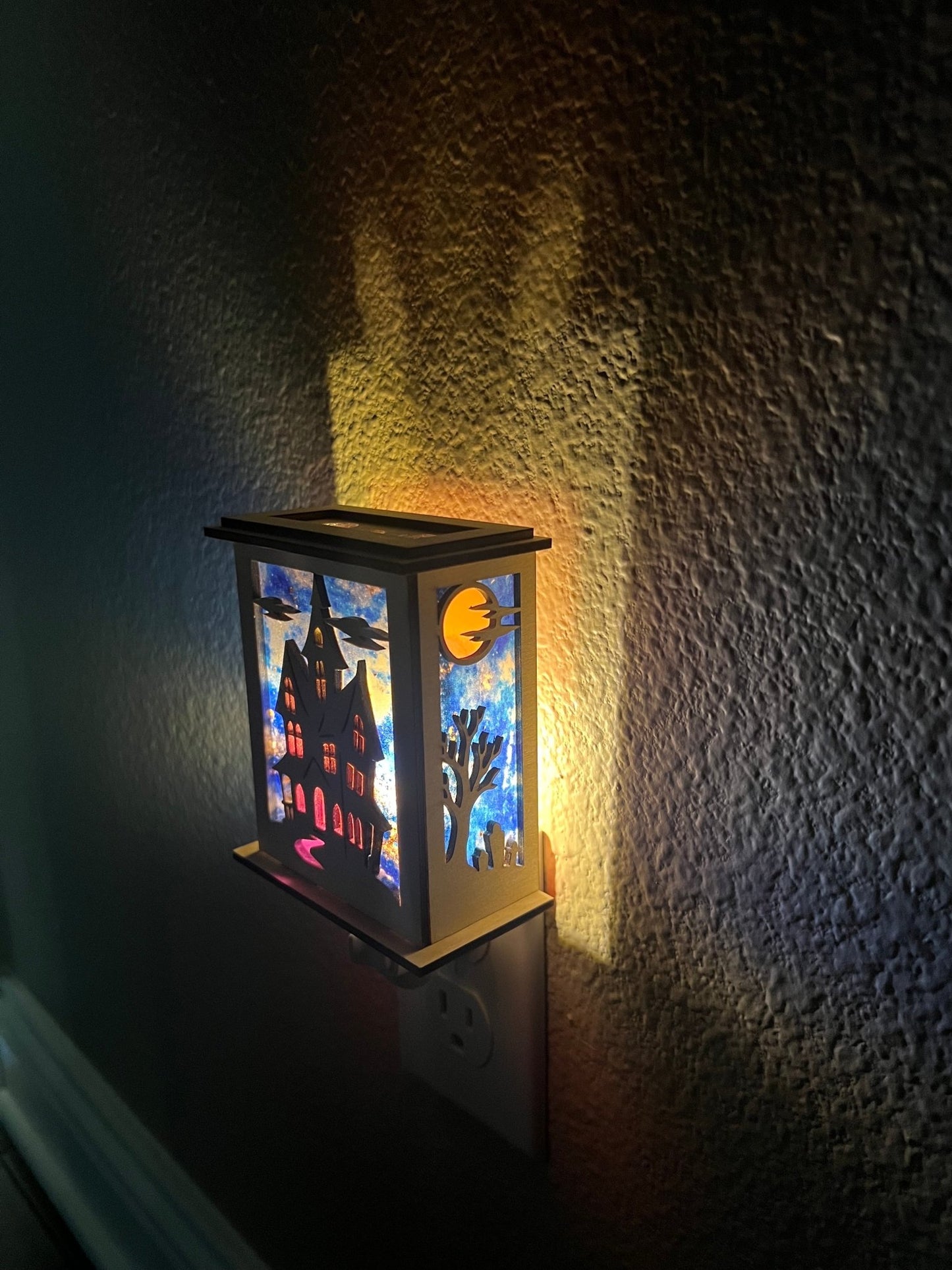 Halloween Haunted House Lantern Nightlight made from wood and acrylic, showcasing rustic charm and multicolor glow lighted in a hall right view.