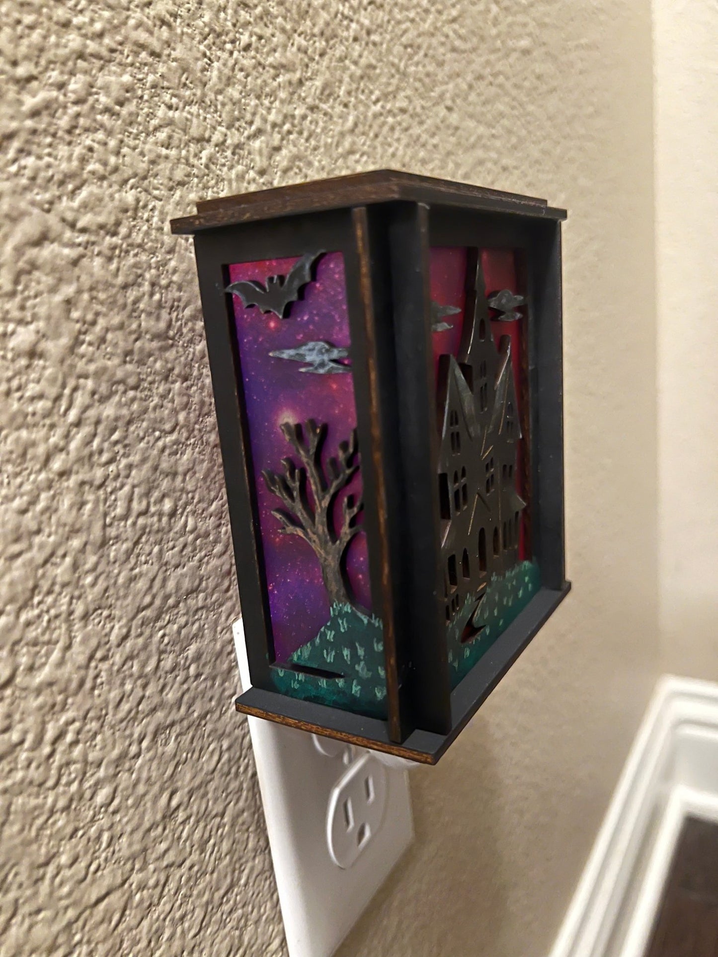 A haunted house hand painted stained glass effect nightlight, multicolor acrylic and black wood design - unlit left side view.