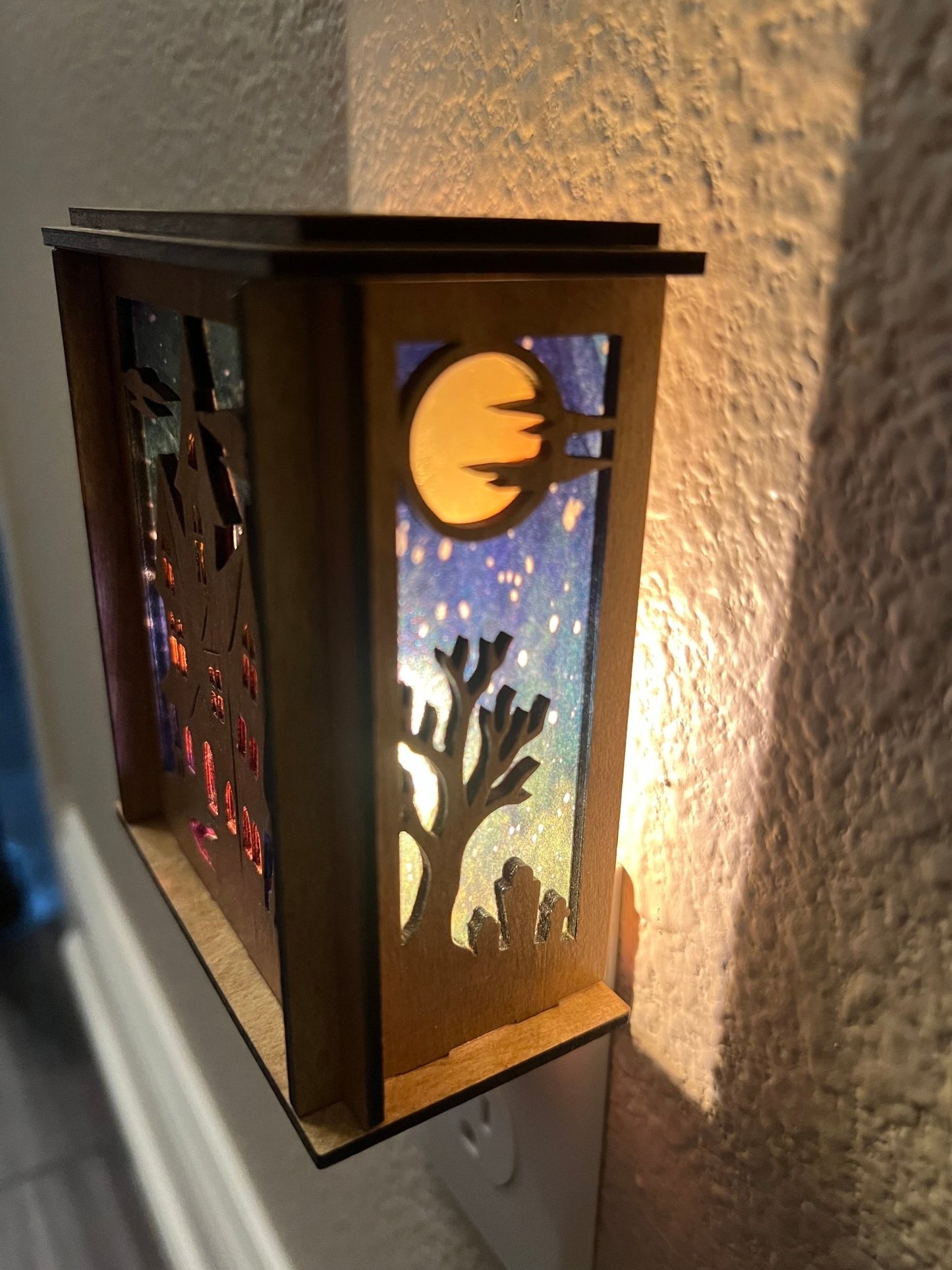 Haunted house nightlight with golden oak stained wood and acrylic stained glass effect, perfect for cozy home decor lit wight side view lights on.