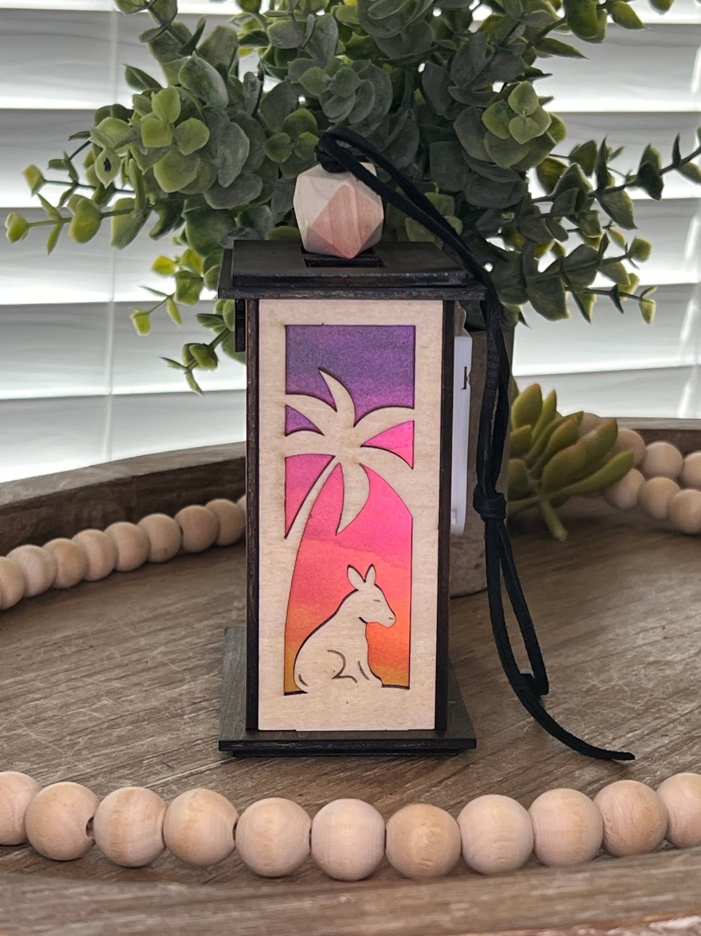 Lighted Christmas Nativity Lantern Ornament made with a natural and walnut stain and acrylic, right side, lighted view.