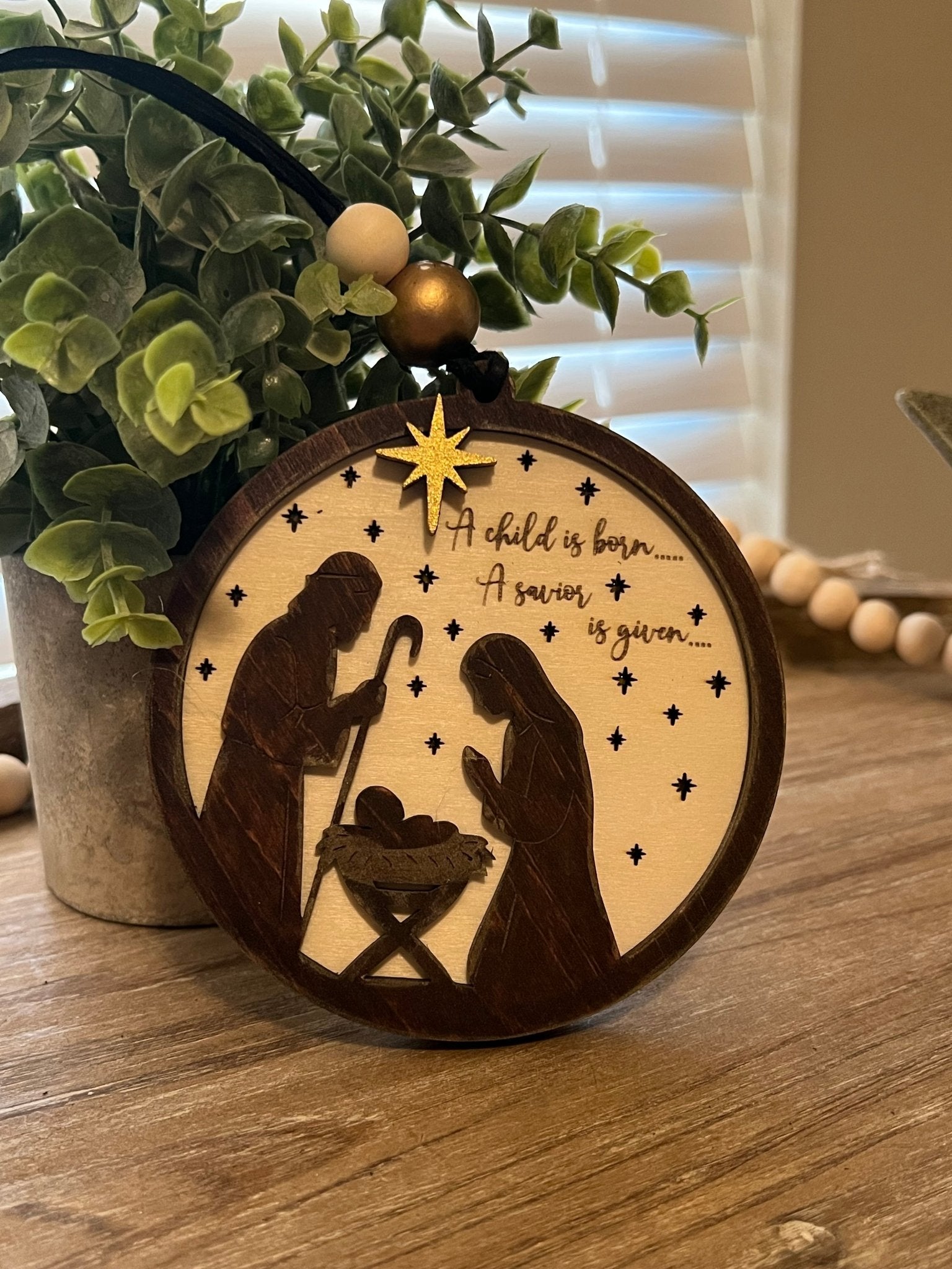 Lighted Christmas Nativity Ornament in natural wood with walnut stain.