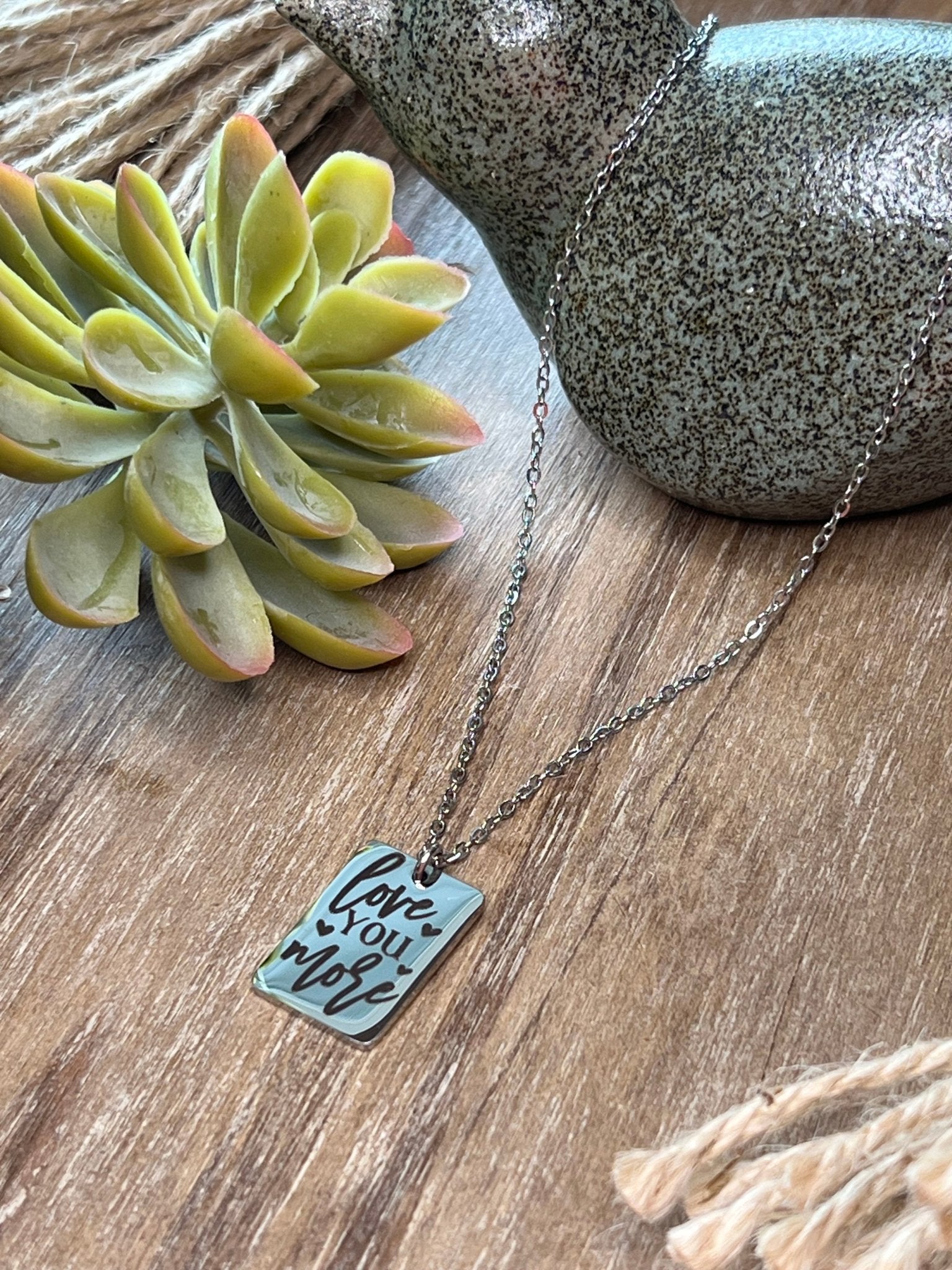 Engraved silver necklace made of stainless steel with a love message.