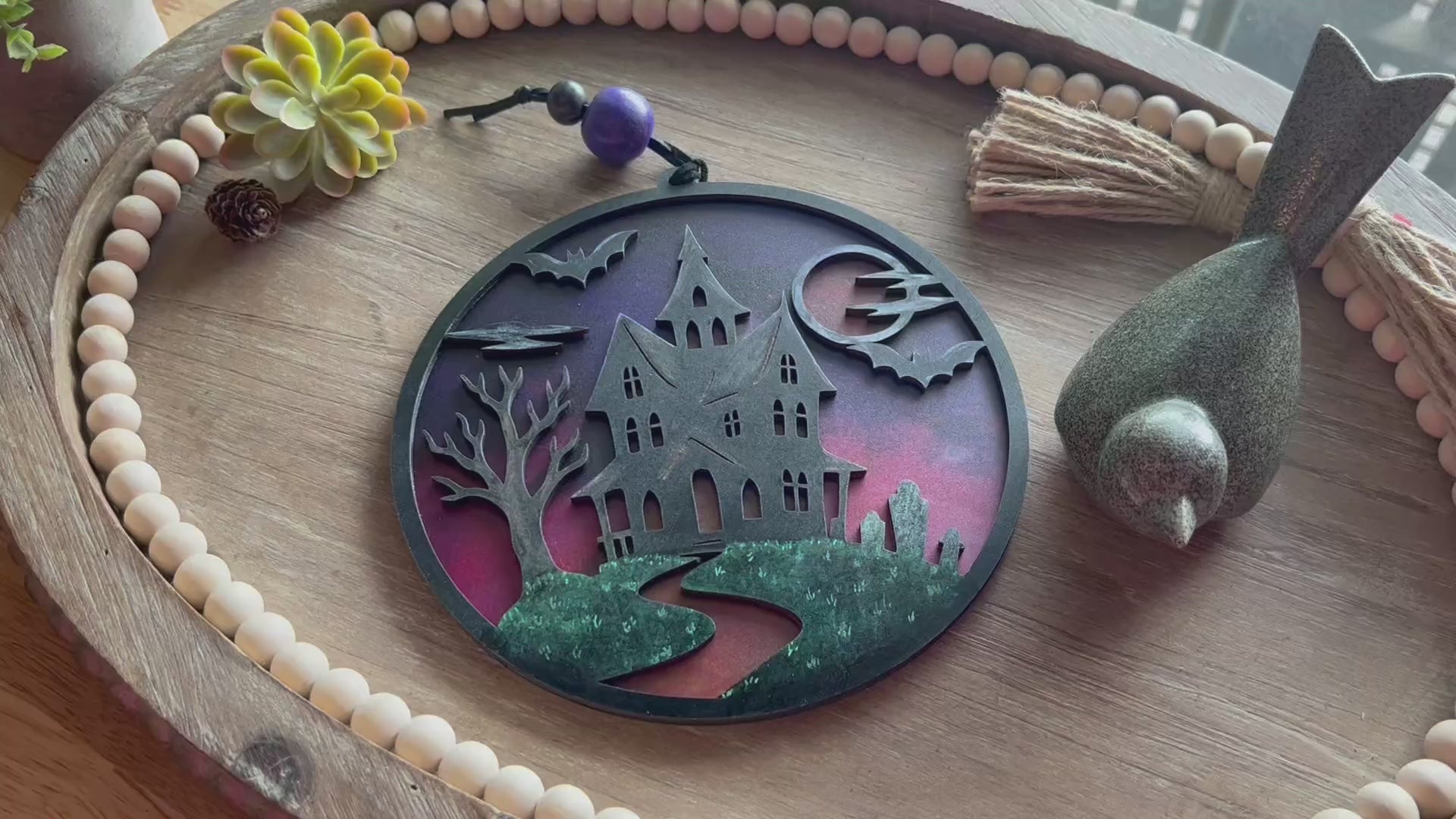 Hand painted suncatcher with a haunted house design on wood and acrylic, in vibrant colors - unlit front view video.