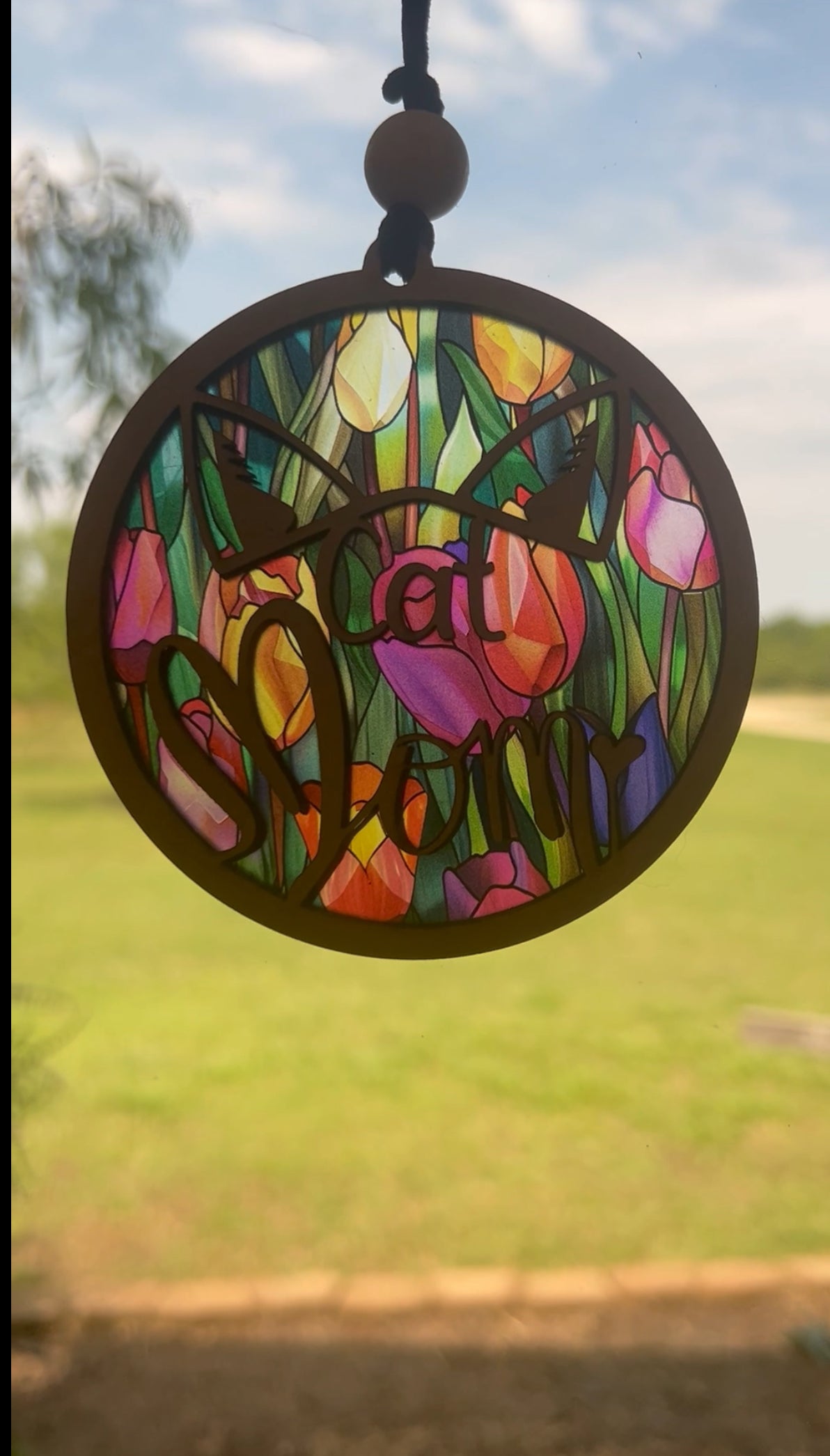 Tulip Cat Mom Suncatcher made of natural wood and multicolor acrylic with stained glass effect lighted.
