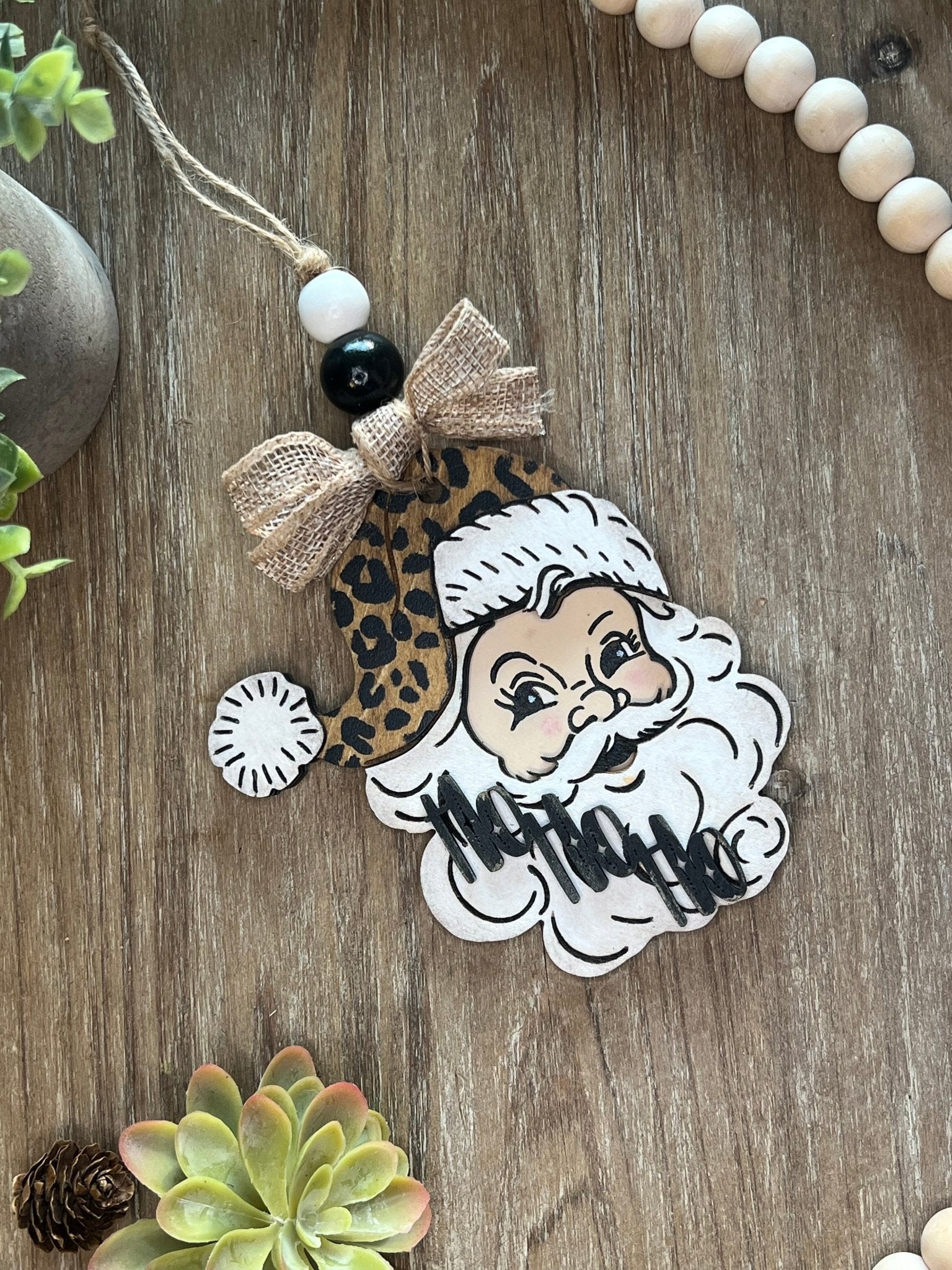 Vintage Santa Christmas Ornament with a leopard hat, made of natural wood.