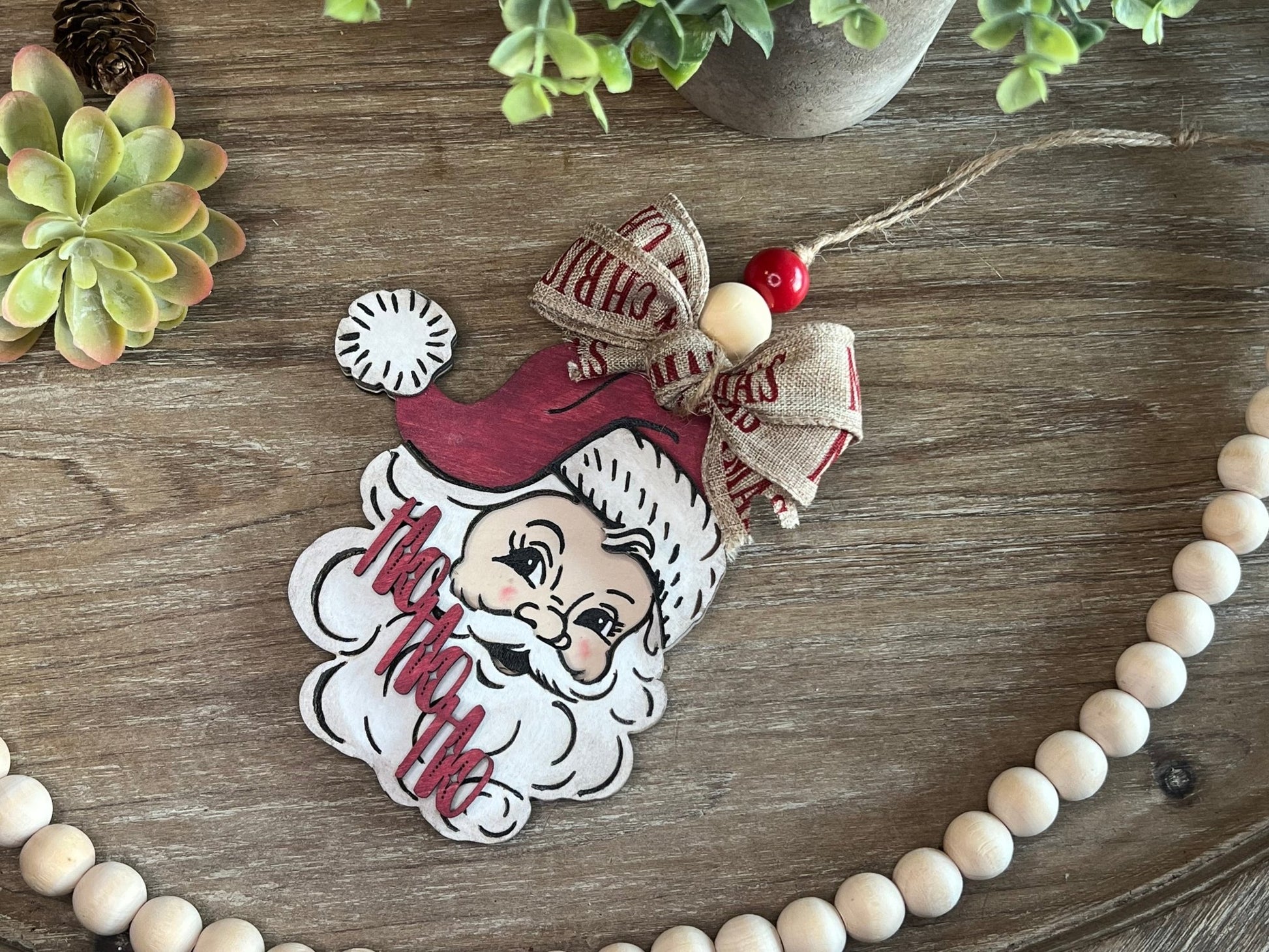 Vintage Santa Christmas Ornament with red hat, wooden and rustic zoomed in.