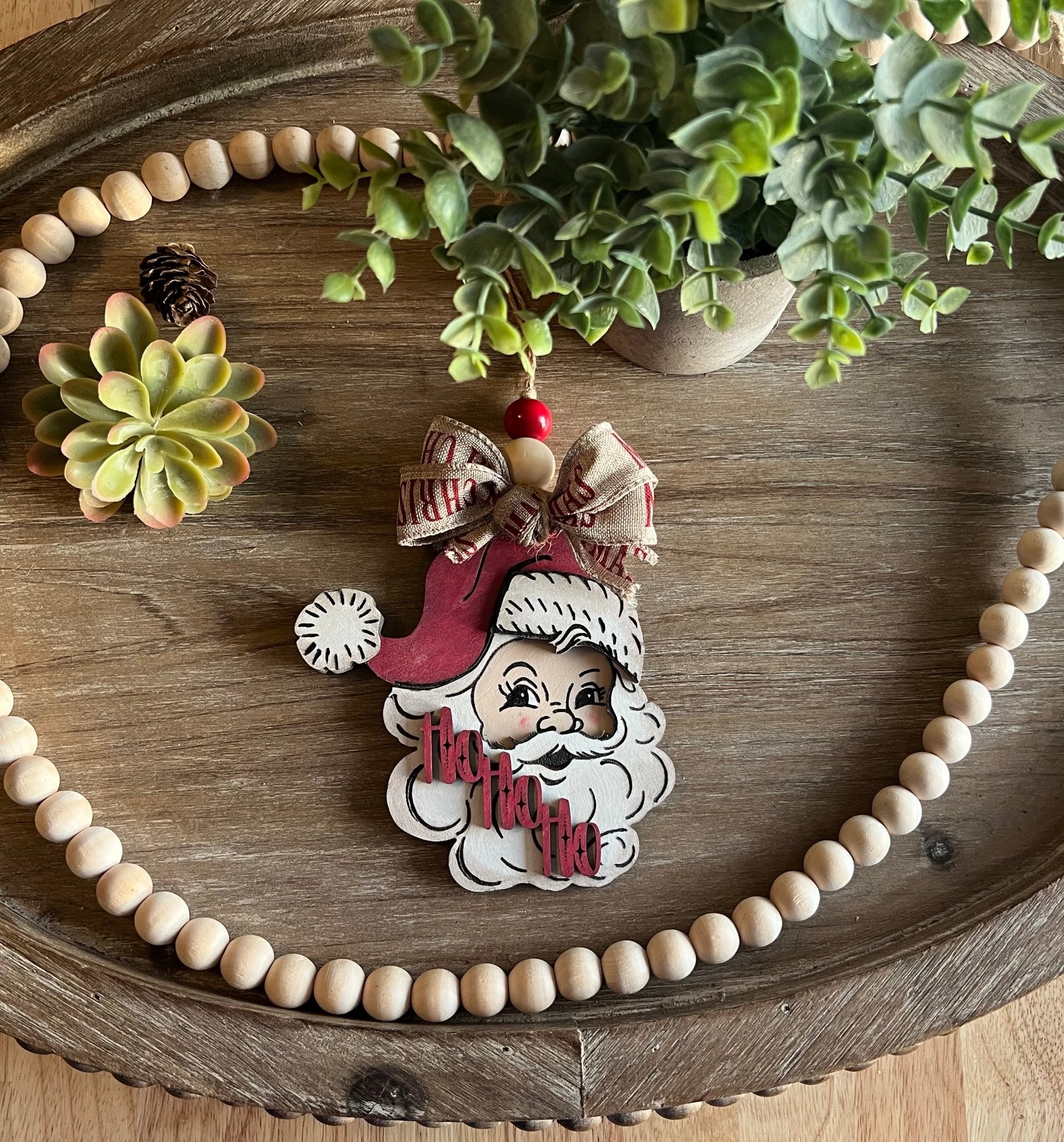 Vintage Santa Christmas Ornament with red hat, wooden and rustic in natural light.